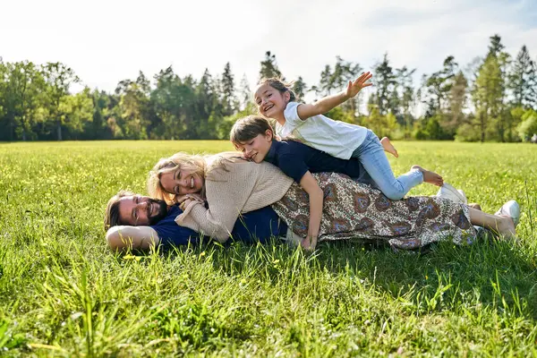 Happy Family Enjoying While Lying Grass Sunny Day — Stock Photo, Image