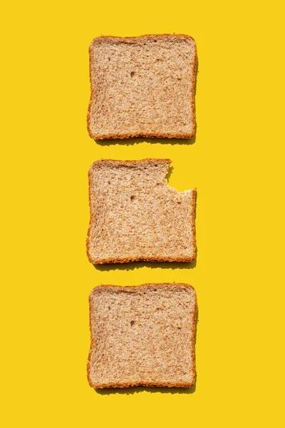 Studio Shot Three Slices Wheat Bread Yellow Background — Stock Photo, Image