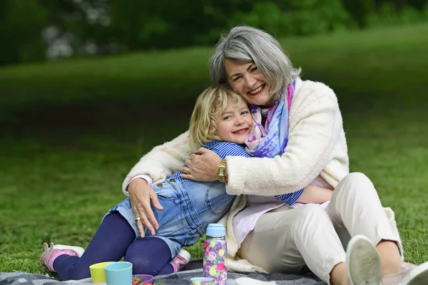 Affectionate Grandmother Granddaughter Embracing While Sitting Public Park — Stock Photo, Image