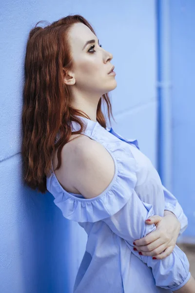 Redheaded Woman Leaning Blue Wall — Stock Photo, Image