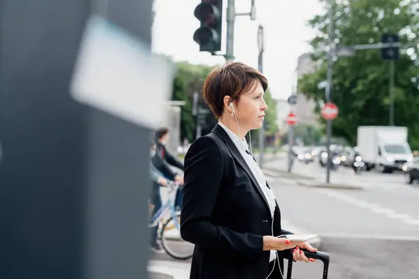 Businesswoman Listening Music Headphones Looking Away While Standing Street City — Stockfoto