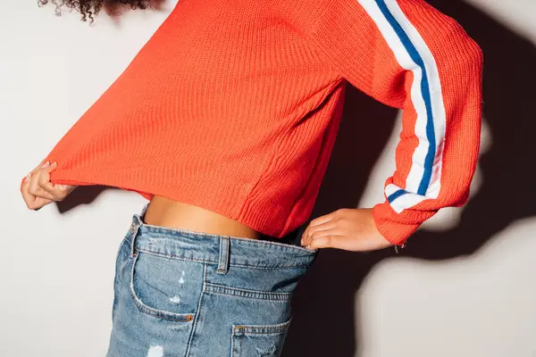 Close Woman Pulling Jeans Shirt While Standing White Background — Stock Photo, Image