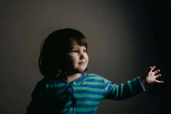 Cute Baby Girl Looking Away While Standing Gray Wall Home — Stock Photo, Image