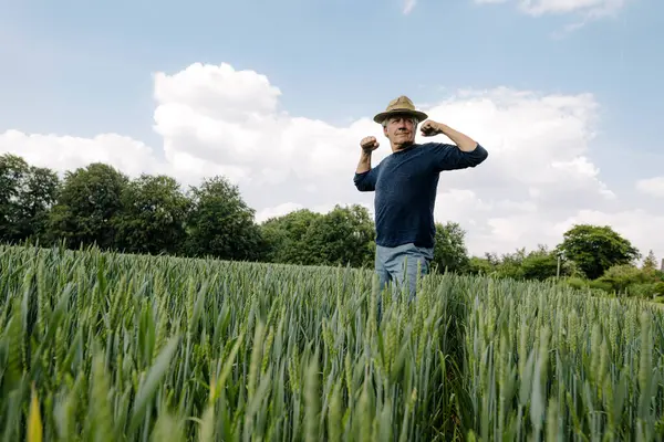 Confident Man Flexing Muscles Cloudy Sky Field — Stock Photo, Image