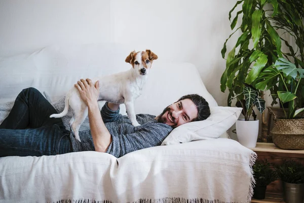 Happy Man Smiling While Playing Pet Lying Sofa Home — Stock Photo, Image
