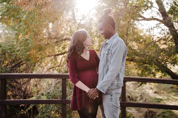 Multi Ethnic Couple Looking Each Other While Standing Footbridge Park — Stock Photo, Image