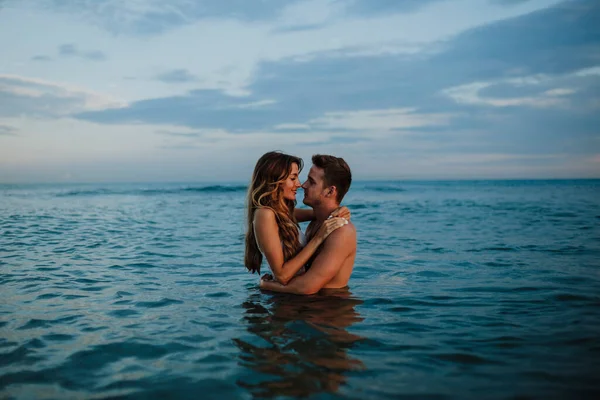 Çiftler Sahilde Suyun Içinde Dururken Romantizm Yapıyorlar — Stok fotoğraf