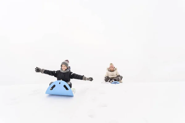 Playful Sister Brother Sledding Snow Covered Hill — 图库照片