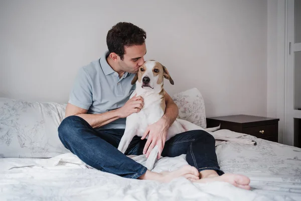 Mid Adult Man Kissing Dog While Sitting Bed Wall Home — Stock Photo, Image