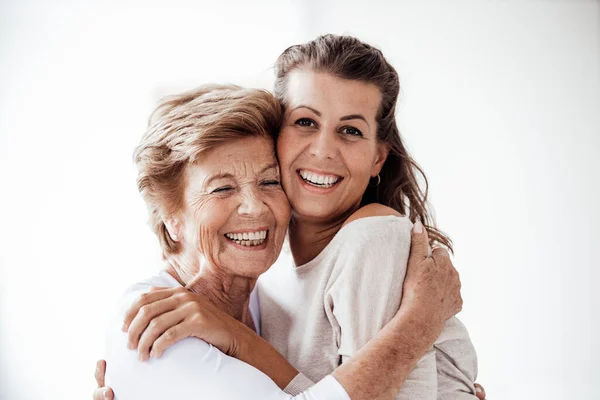 Cheerful Senior Woman Embracing Smiling Granddaughter — Stock Photo, Image