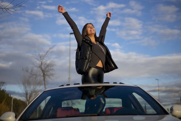 Happy Woman Hand Raised Standing Car Sun Roof Sky — Stock Photo, Image