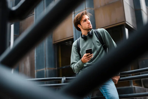 Male Student Mobile Phone Looking Away While Leaning Railing University — Stock Photo, Image