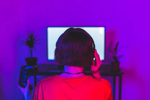 Woman Adjusting Headphones While Playing Video Game Home — Stock Photo, Image
