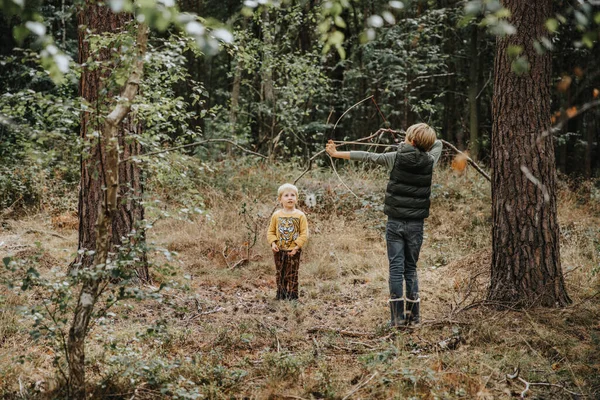 Boy Playing Bow Arrow While Brother Standing Him Forest — Stock Photo, Image