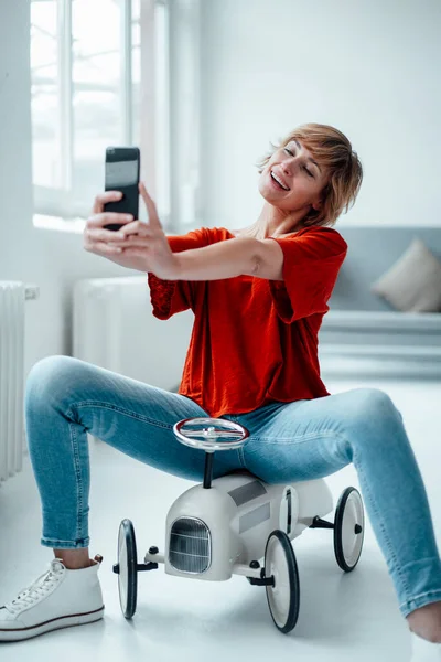 Smiling Businesswoman Taking Selfie Mobile Phone While Sitting Toy Car — Stock Photo, Image