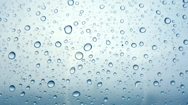 Close-up of water drops on glass surface as background — Stock Photo, Image