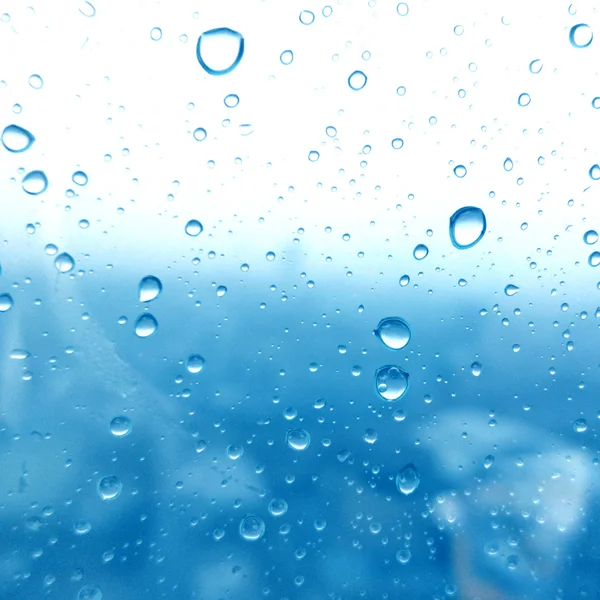 Close-up of water drops on glass surface as background — Stock Photo, Image