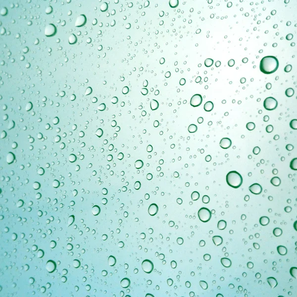 Close-up of water drops on glass surface as background — Stock Photo, Image