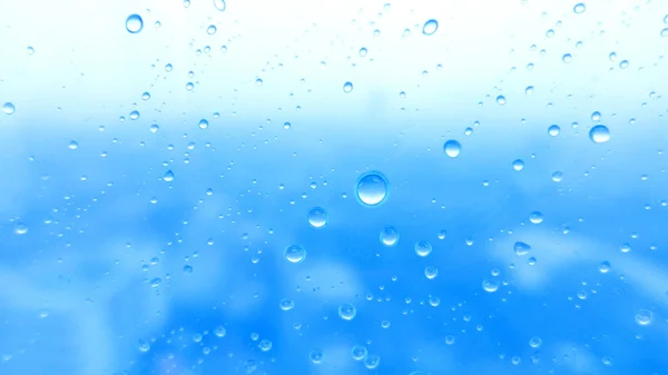 Close-up of water drops on glass surface as background — Stock Photo, Image