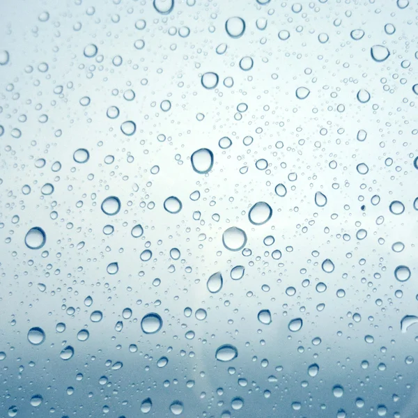 Close-up of water drops on glass surface as background — Stock Photo, Image