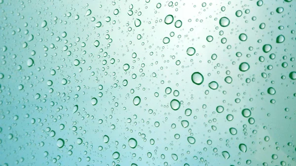 Close-up of water drops on glass surface as background — Stock Photo, Image