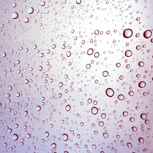 Close-up of water drops on glass surface as background — Stock Photo, Image