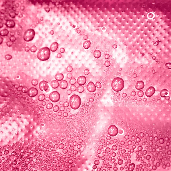 Water drops on a pink background — Stock Photo, Image