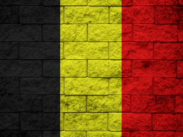 La bandera belga pintada en la pared grunge —  Fotos de Stock