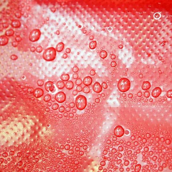 Water drops on a red background — Stock Photo, Image