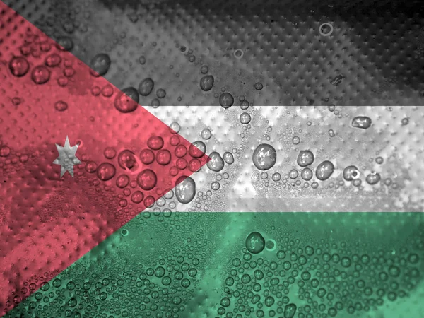 Krople wody na tle flaga Jordanii — Zdjęcie stockowe