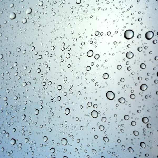 Close-up of water drops on glass surface as background — Stock Photo, Image