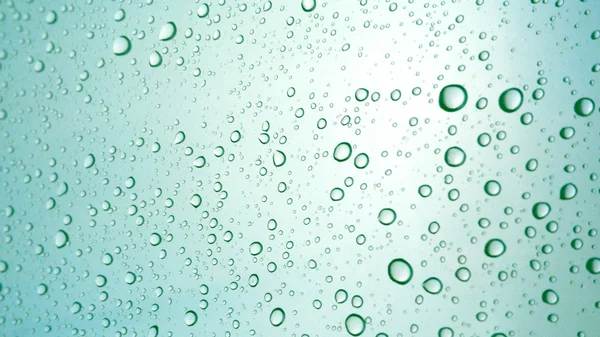 Close-up of water drops on glass surface as background — Stock Photo, Image