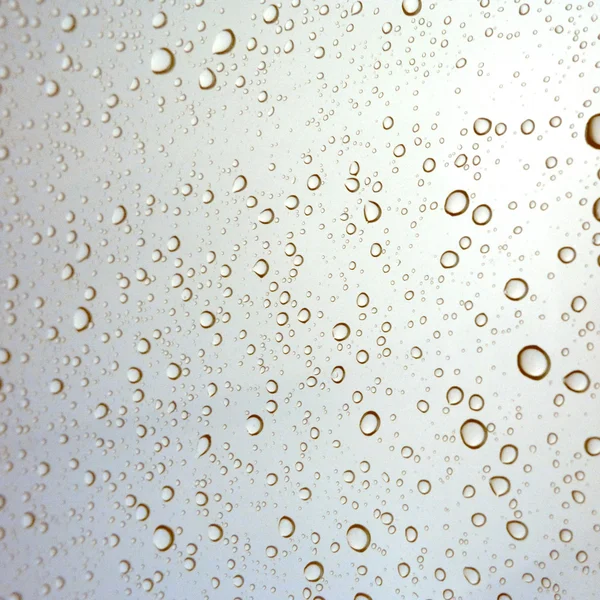 Close-up of water drops on glass surface as background — Stock Photo, Image