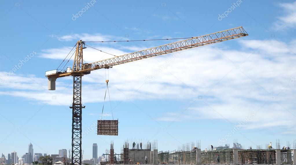 Industrial landscape with cranes on the blue sky