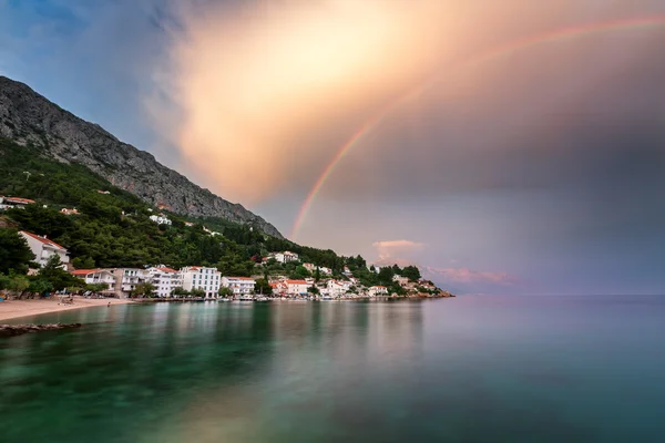 Regnbåge över den lilla byn i Omis Riviera efter regn — Stockfoto