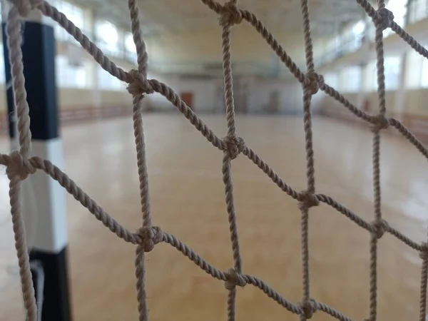 Football goal net close-up. In a sports complex. The old grid in the game room.