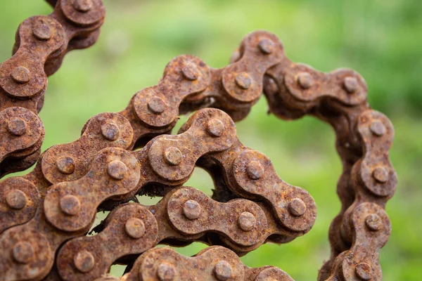 Rusty motorcycle chain. Old motorcycle chain with rust. Motorcycle parts unusable. Close-up.