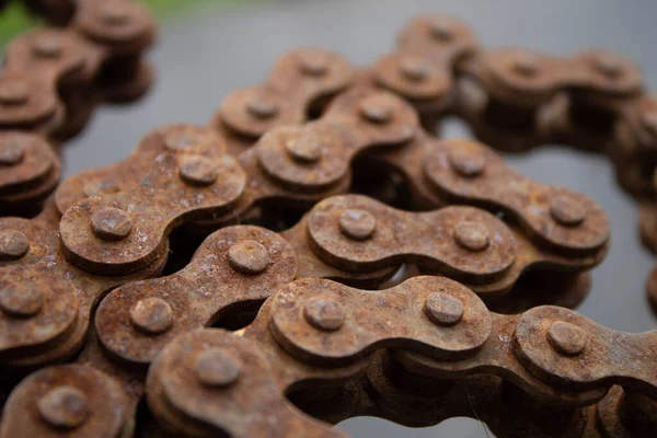 Rusty motorcycle chain. Old motorcycle chain with rust. Motorcycle parts unusable. Close-up.