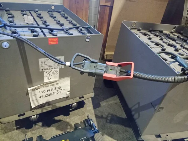 Industrial storage batteries. Charging the battery of the electric forklift. Warehouse equipment. Large battery on charge.