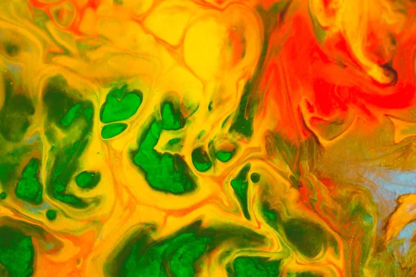 Abstract background from spilled paints. Multi-colored paints on canvas.