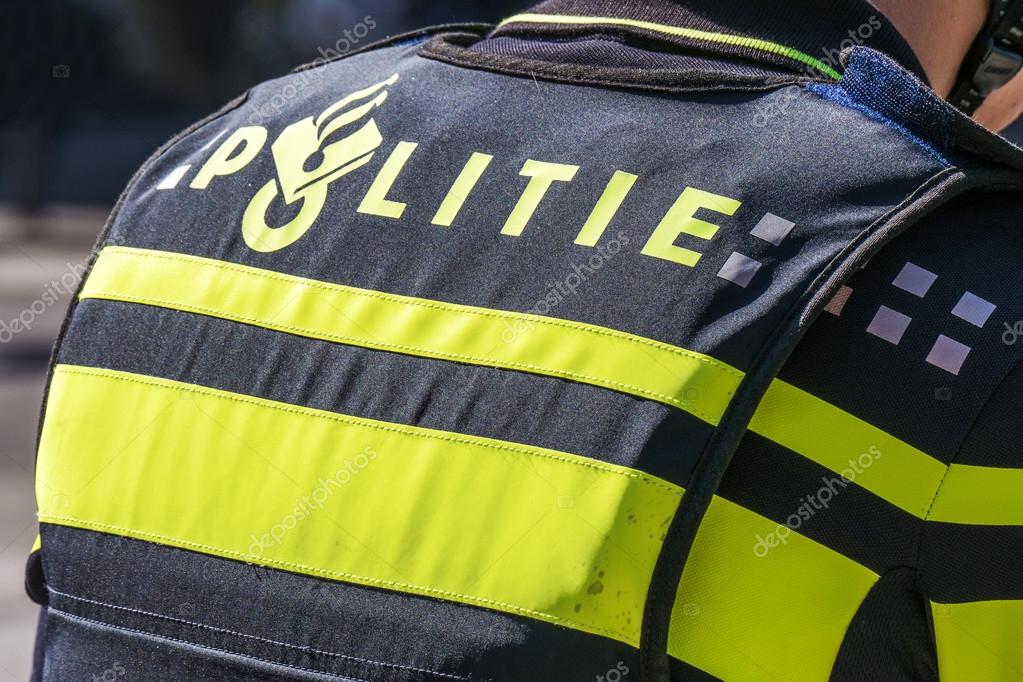 NETHERLANDS - THE HAGUE - SEPTEMBER 11, 2015: Shot of the back of a Dutch police officer's jacket with the word politie in The Hague, near by the government buildings.