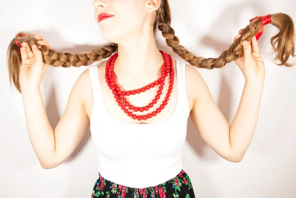 A young beautiful woman with long blonde hair tresses wearing a Polish folk costume — Stock Photo, Image