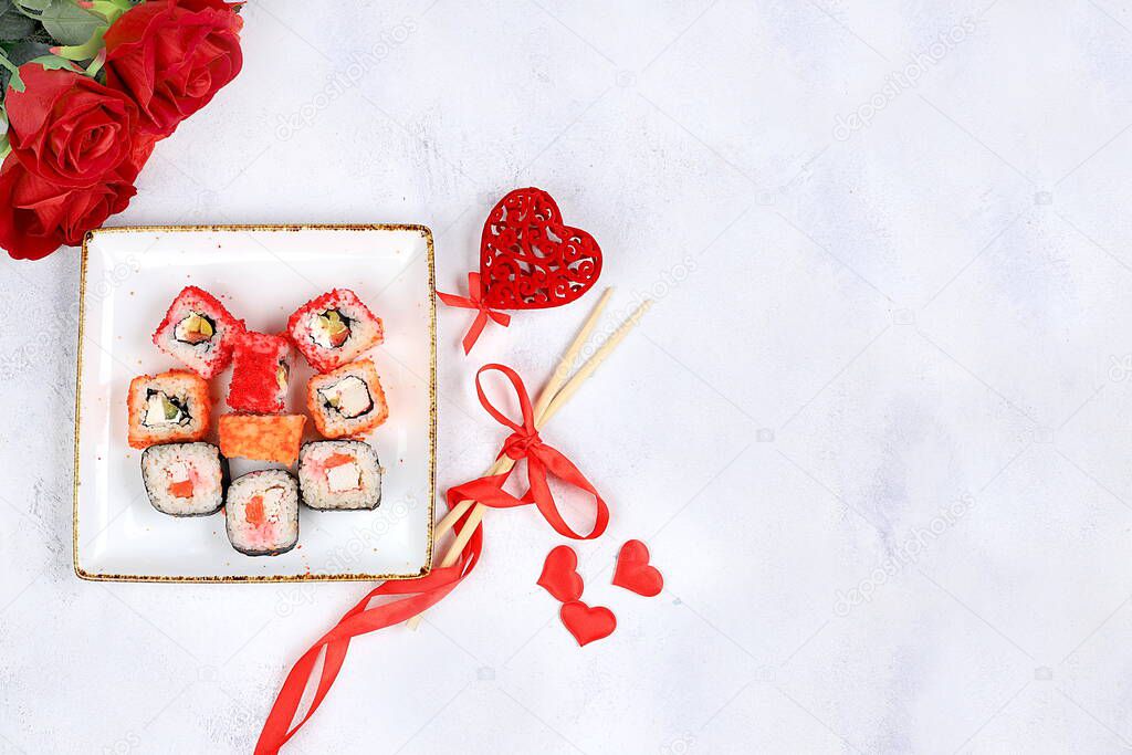 Heart of fresh sushi rolls with roses, valentine's day food, traditional japanese cuisine, place for text, top view, banner for shop advertisement or invitation,