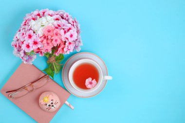 Soyut çiçek kompozisyonu, bahar arkaplanı, asgari tatil konsepti, kartpostal, çay ve çiçekli kadın çalışma masası, düz yatak. Anneler Günü ve Kadınlar Günü 'nü kutlarım.,