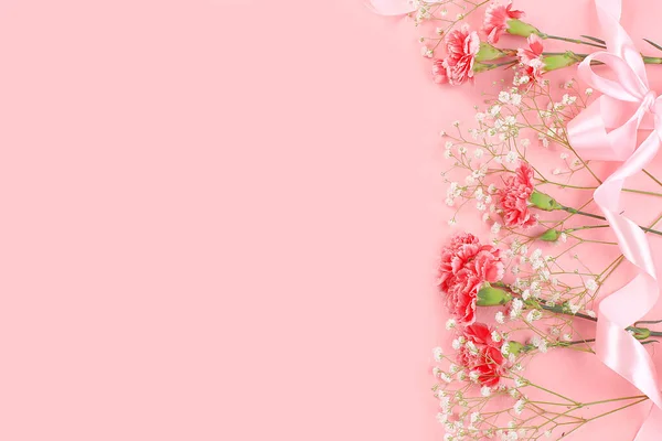 Abstract floral composition, spring background. Carnations on pink background, minimal holiday concept. Postcard for womens day or mothers day, happy birthday, wedding, banner for the screen,