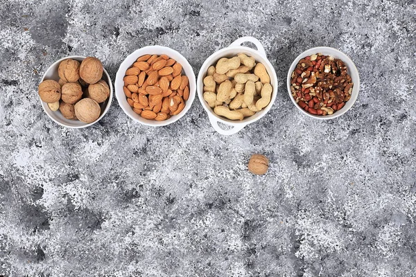Assortment of different nuts, the concept of healthy natural food, almonds, pecans, pistachios, cashews, walnuts and pine nuts, high-calorie food with vegetable protein and vitamins, the basis of diet food, selective focus