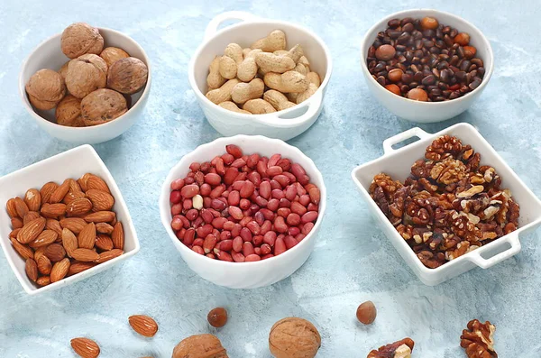 Assortment of different nuts, healthy natural food concept, almonds, pecans, pistachios, cashews, walnuts and pine nuts, high-calorie food with vegetable protein and vitamins,