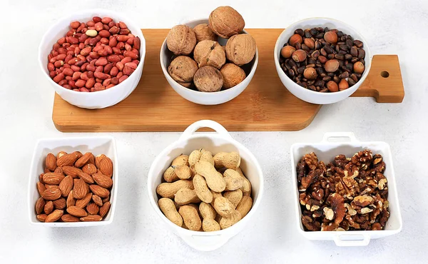 Assortment of different nuts, healthy natural food concept, almonds, pecans, pistachios, cashews, walnuts and pine nuts, high-calorie food with vegetable protein and vitamins,