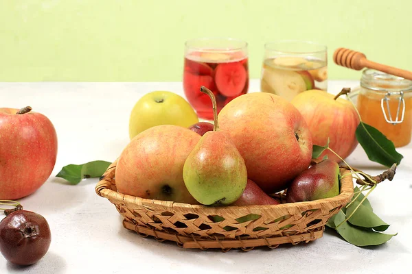 Apple and pear cider, juice or fruit drink and ingredients on a sunny table. The concept of diet and weight loss. Apples help cleanse the body and reduce weight. Healthy eating, body detoxification