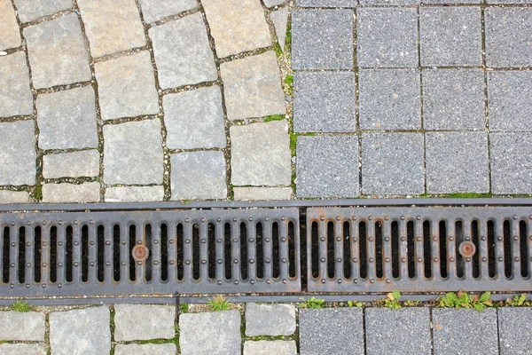 Drain and stone pavement — Stock Photo, Image